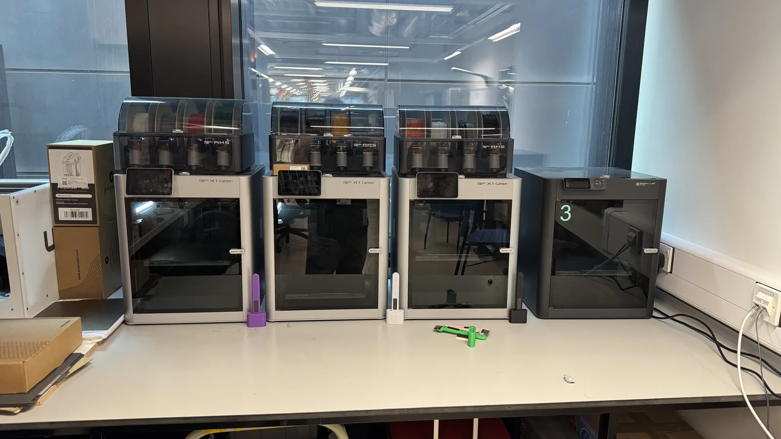 A bank of Bambu Lab printers prepared for rapid prototype work.